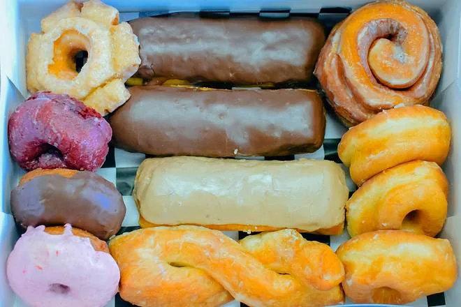 An open box packed with an assortment of Doughboys donuts