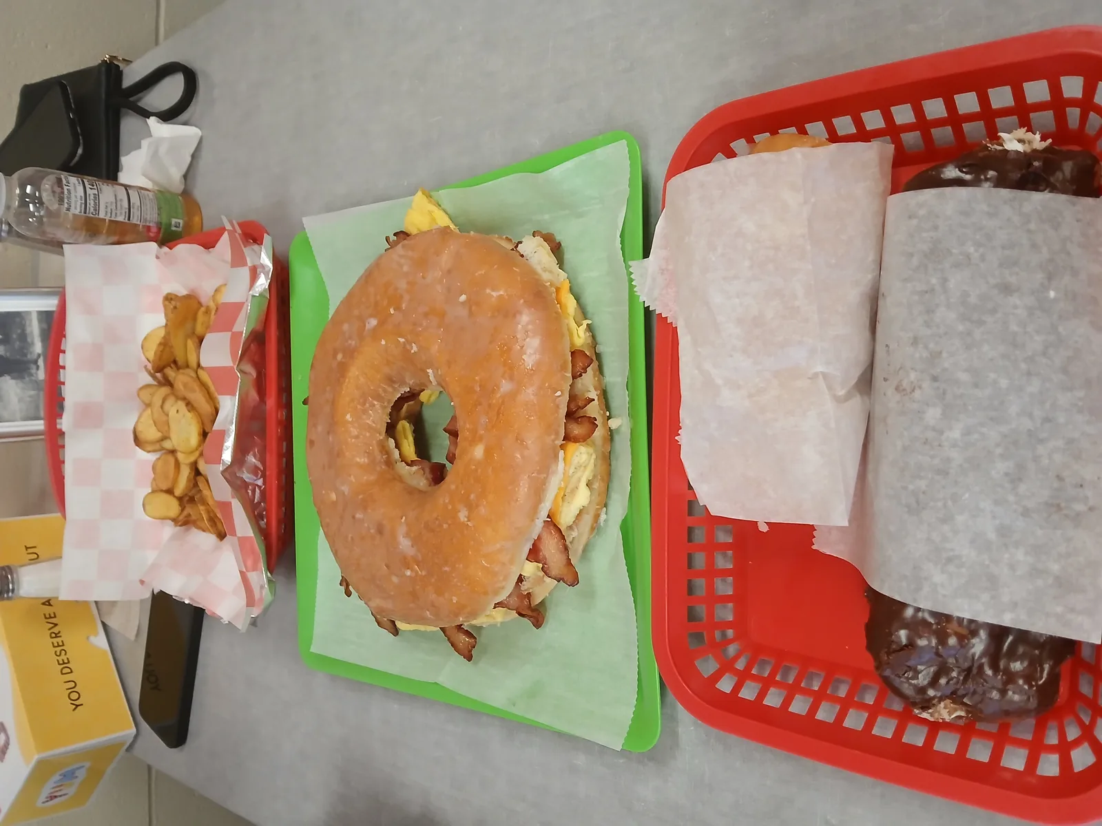 A full Doughboys breakfast order: donut slider, breakfast burrito and fried potatoes