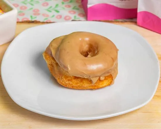 A caramel iced white cake donut