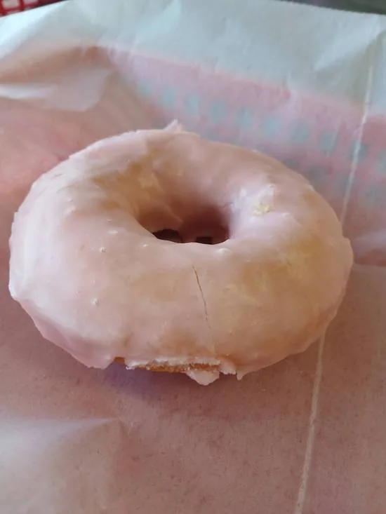 A cherry iced white cake donut