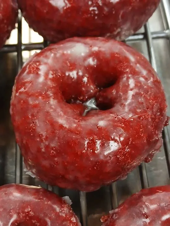 A glazed red velvet cake donut